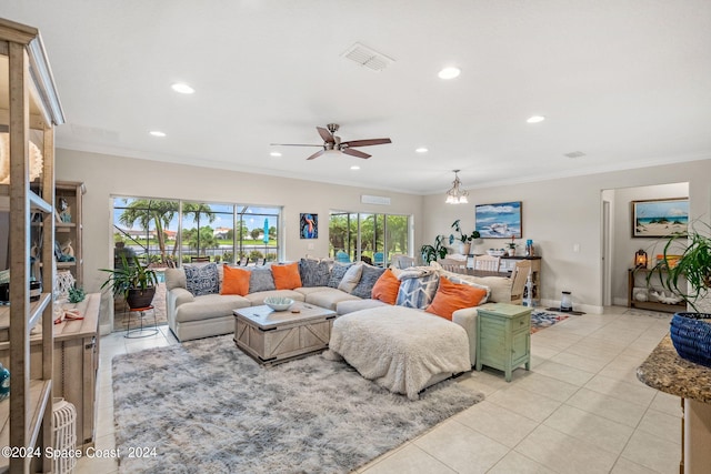 tiled living room featuring ceiling fan with notable chandelier and crown molding