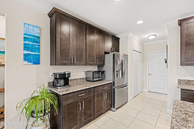 kitchen with crown molding, dark brown cabinets, and stainless steel fridge