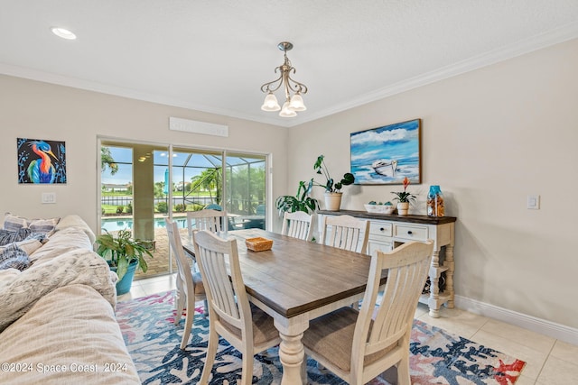 tiled dining area featuring a chandelier and crown molding