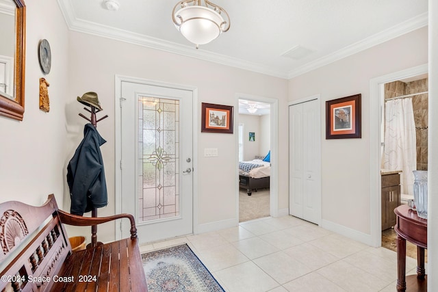 tiled foyer entrance featuring ceiling fan and crown molding