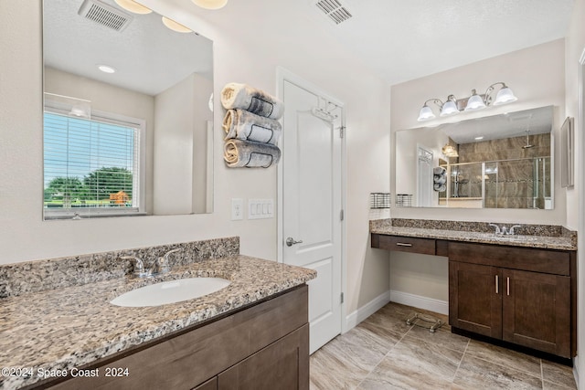 bathroom with walk in shower and vanity