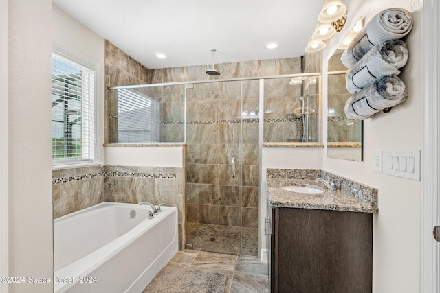 bathroom with separate shower and tub and vanity