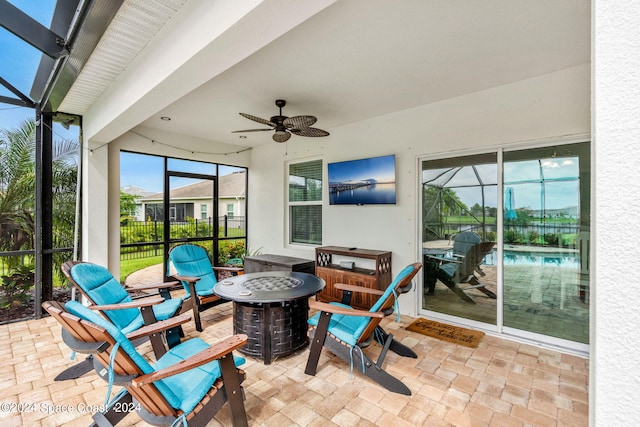 sunroom featuring ceiling fan