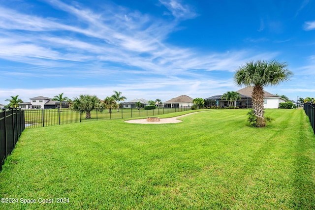 view of yard featuring an outdoor fire pit