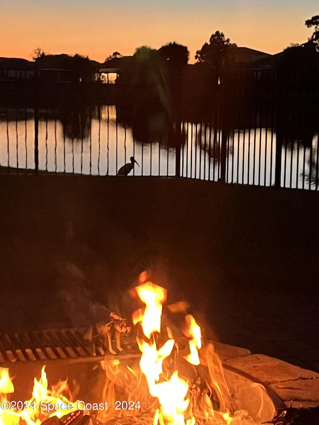 property view of water with an outdoor fire pit