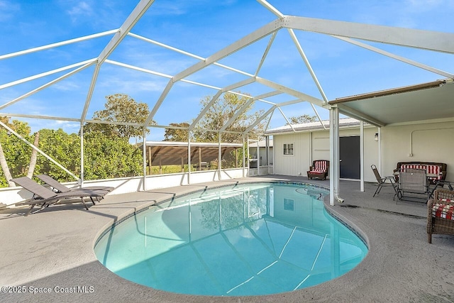 view of swimming pool featuring a patio and glass enclosure