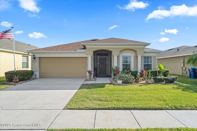 view of front facade with a garage and a front yard