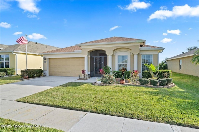 view of front of home featuring a front lawn and a garage