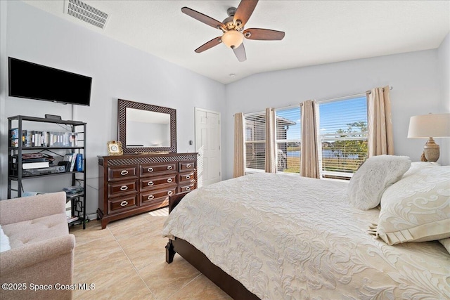 tiled bedroom with lofted ceiling and ceiling fan