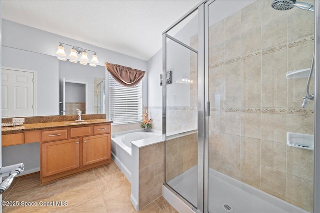 bathroom featuring tile patterned flooring, plus walk in shower, vanity, and a textured ceiling