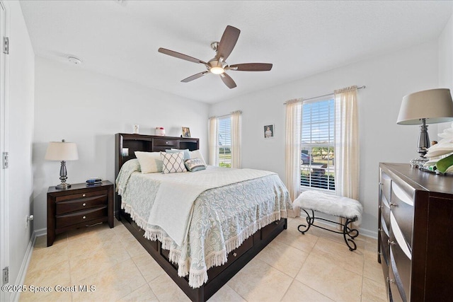 bedroom with light tile patterned floors and ceiling fan