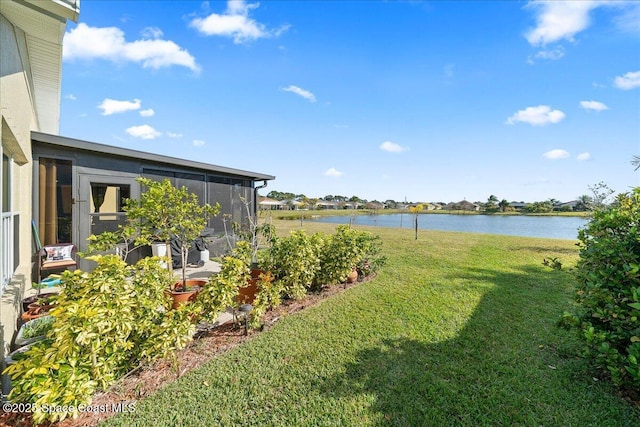 view of yard with a water view and a sunroom