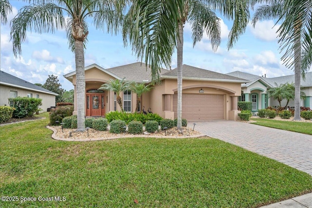 ranch-style home with a front lawn and a garage