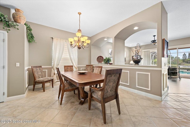 dining room featuring ceiling fan with notable chandelier