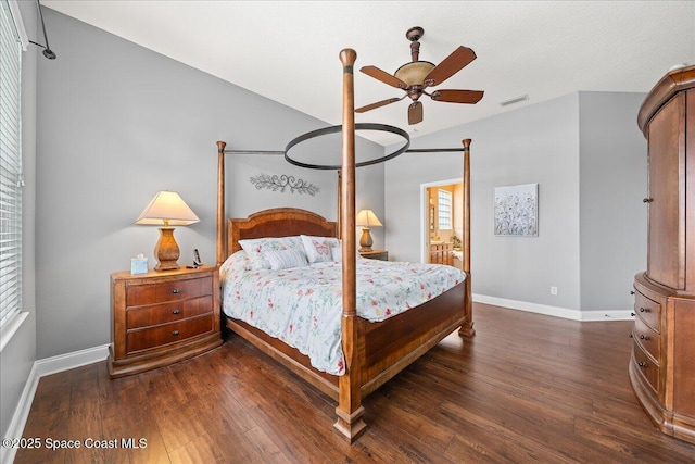 bedroom with ceiling fan, dark hardwood / wood-style floors, and vaulted ceiling