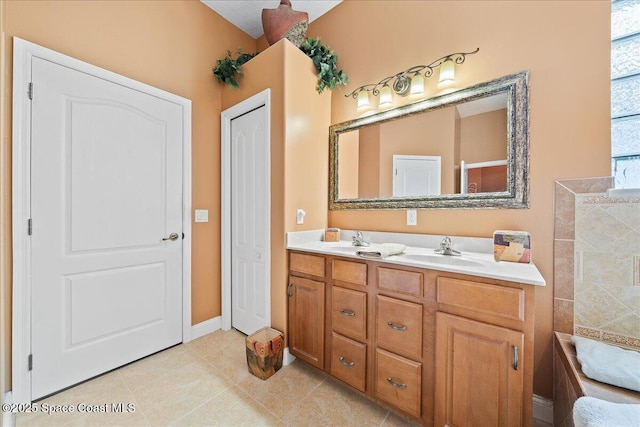 bathroom with tile patterned floors and vanity