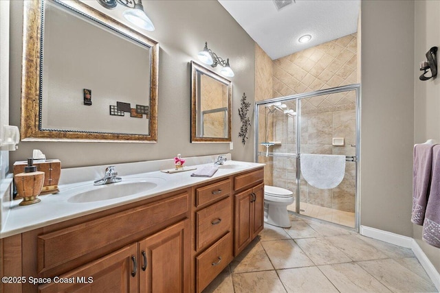 bathroom featuring toilet, tile patterned flooring, walk in shower, and vanity