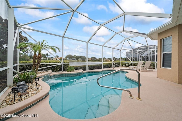 view of pool featuring glass enclosure, a patio area, and a water view