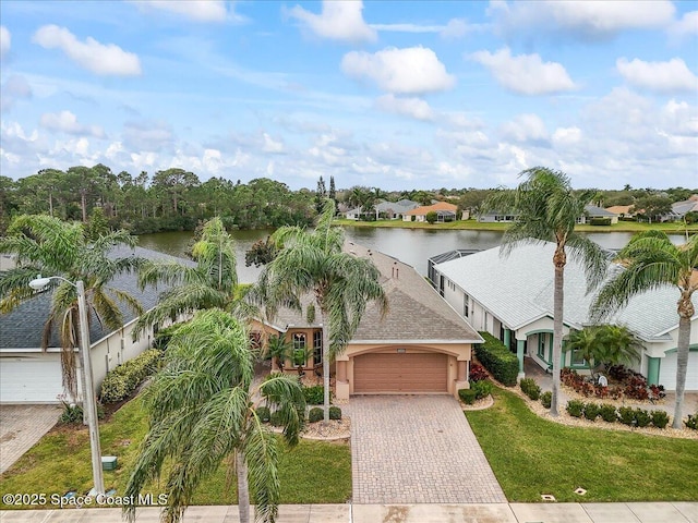 view of front of property featuring a water view, a front lawn, and a garage