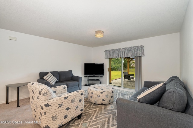 carpeted living room featuring a textured ceiling