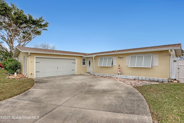 ranch-style home featuring a garage and a front lawn