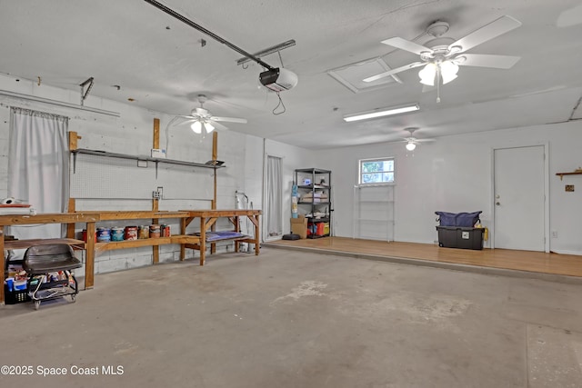 garage with a workshop area and a garage door opener