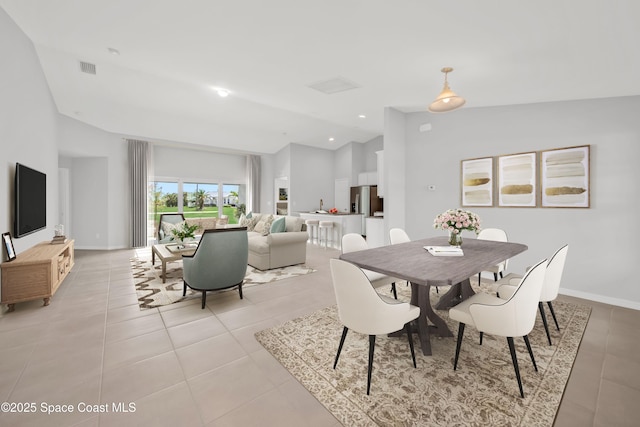 tiled dining area with lofted ceiling