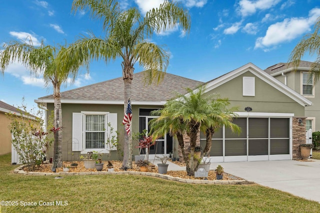 view of front of home featuring a front lawn and a garage