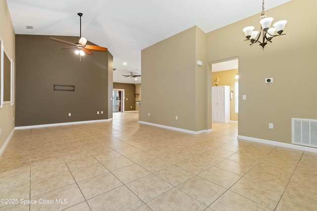 unfurnished room featuring vaulted ceiling, light tile patterned flooring, and ceiling fan with notable chandelier