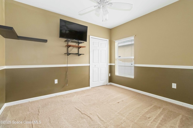 unfurnished bedroom featuring ceiling fan, a closet, and carpet flooring