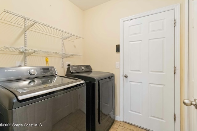 washroom featuring light tile patterned floors and separate washer and dryer