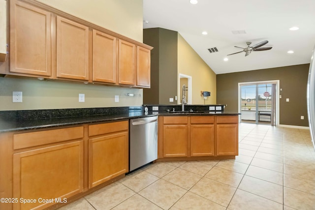 kitchen with kitchen peninsula, ceiling fan, light tile patterned flooring, dark stone counters, and stainless steel dishwasher