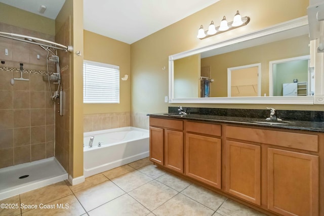 bathroom with plus walk in shower, vanity, and tile patterned flooring