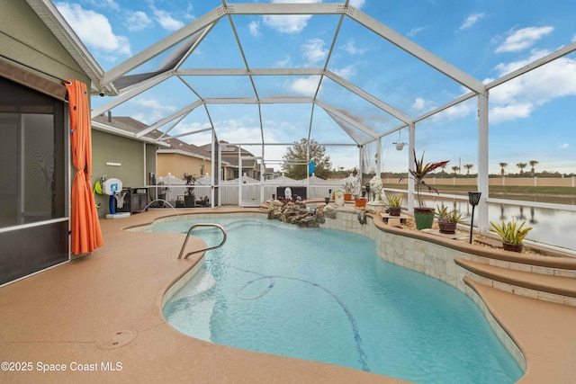 view of pool featuring glass enclosure and a patio area