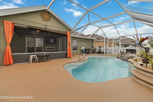 view of swimming pool featuring glass enclosure and a patio