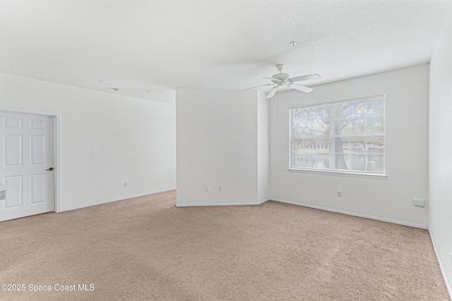 carpeted spare room with ceiling fan and a textured ceiling