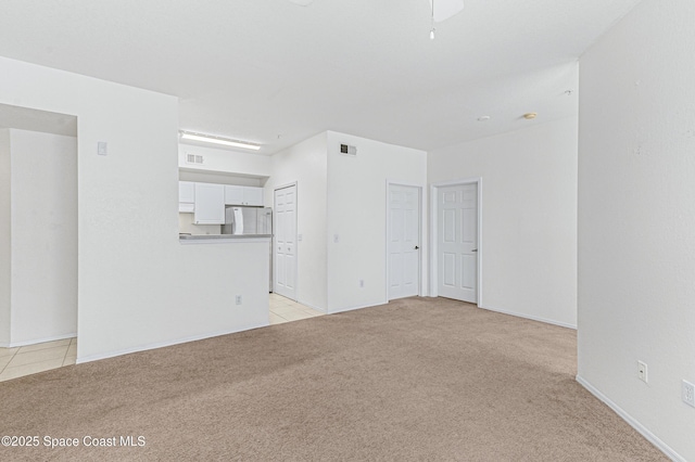 unfurnished living room featuring light carpet