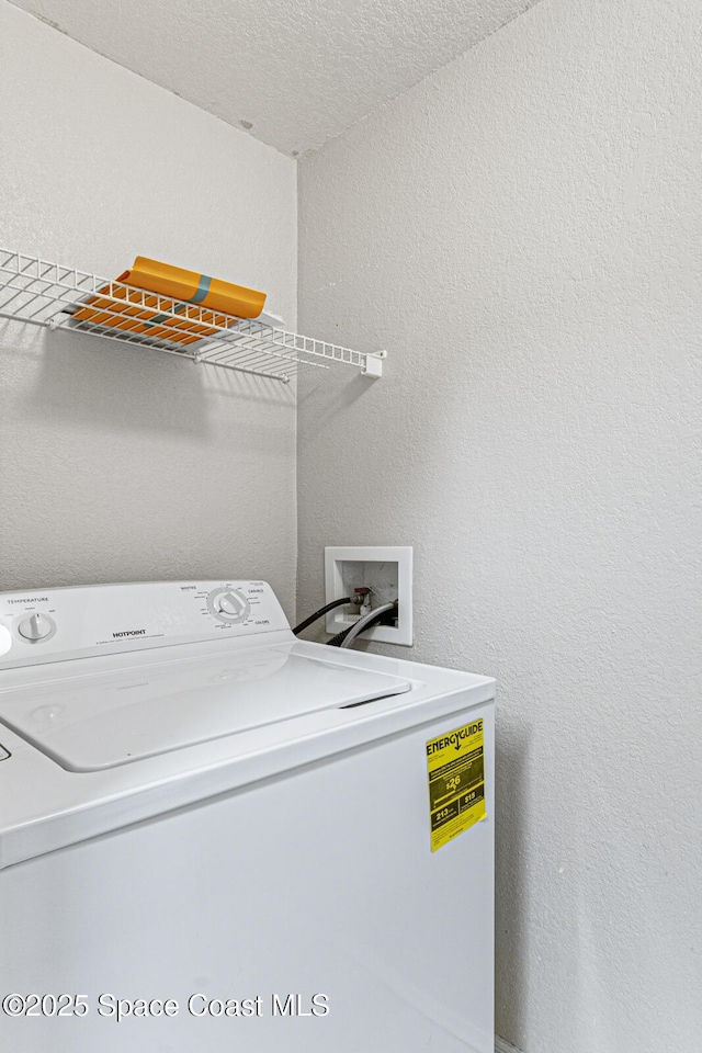 washroom featuring a textured ceiling and washer / clothes dryer