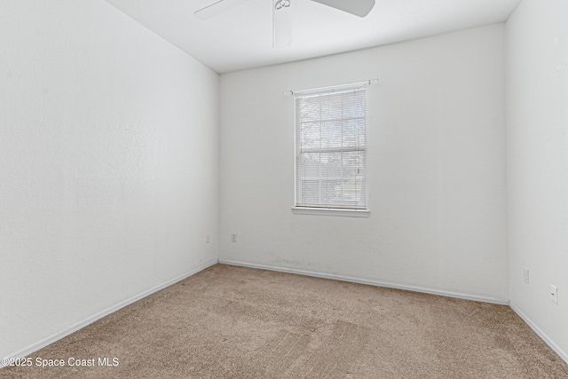 carpeted empty room featuring ceiling fan