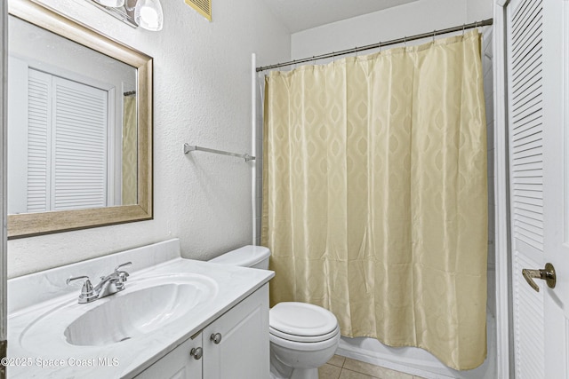 full bathroom with toilet, tile patterned flooring, shower / bathtub combination with curtain, and vanity