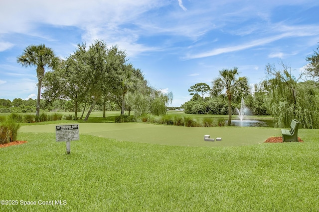 surrounding community with a lawn and a water view