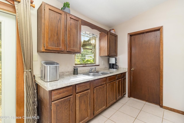 kitchen featuring sink and light tile patterned flooring