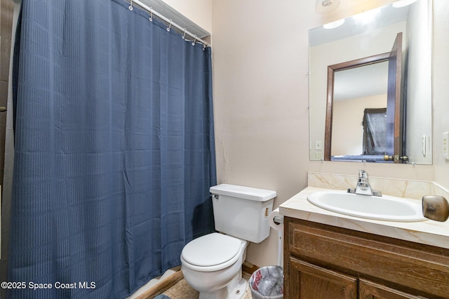 bathroom featuring toilet and vanity