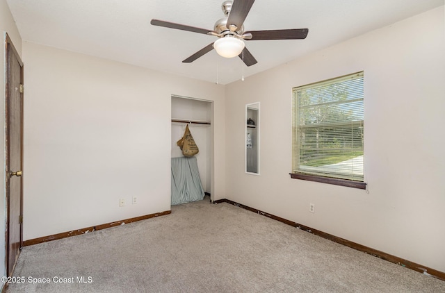 unfurnished bedroom featuring ceiling fan, a closet, and light carpet