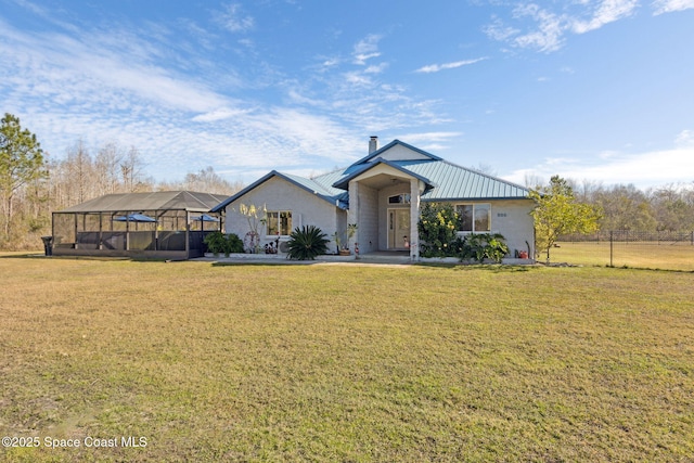 view of front of house featuring a front lawn and glass enclosure