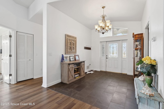 foyer with dark hardwood / wood-style flooring and a notable chandelier