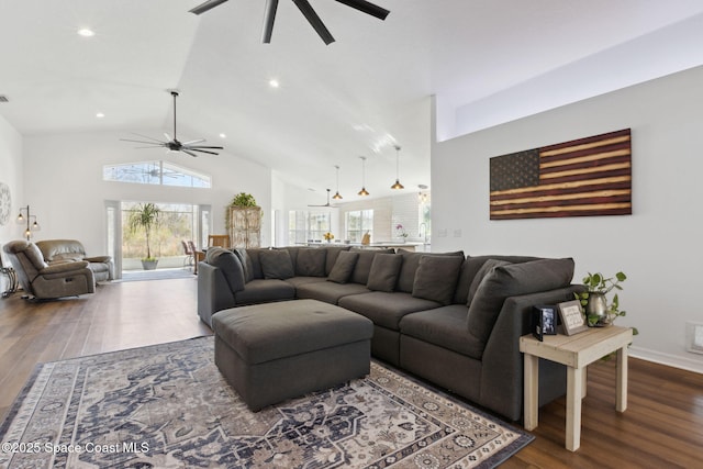 living room with hardwood / wood-style floors, high vaulted ceiling, and ceiling fan