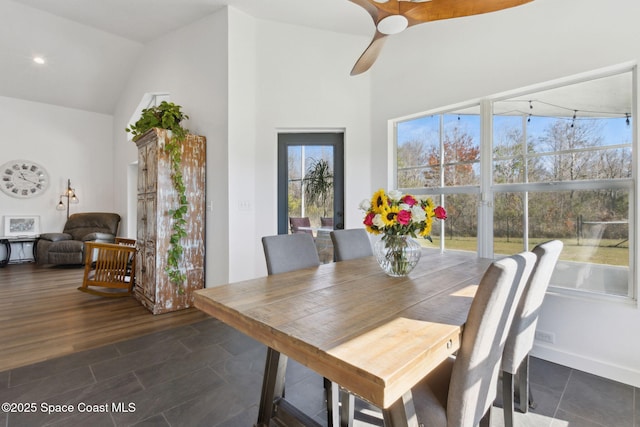 dining area with high vaulted ceiling, dark hardwood / wood-style floors, and ceiling fan