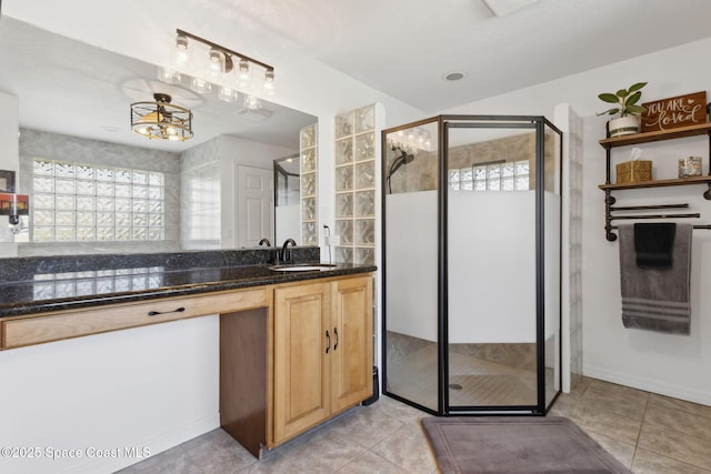 bathroom featuring vanity, tile patterned flooring, and a shower with door