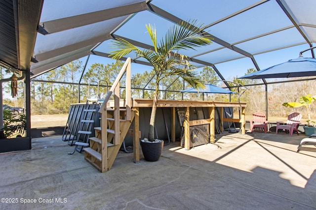 view of patio / terrace with exterior bar and a lanai